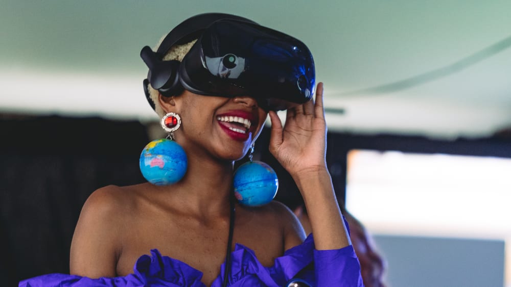 Student in VR headset and wearing globe earrings