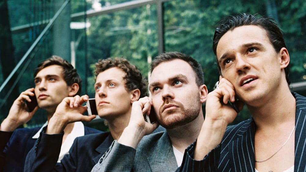 A row people holding phones to their ears