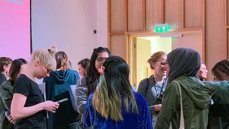 A group of attendees chatting at a CCI workshop event