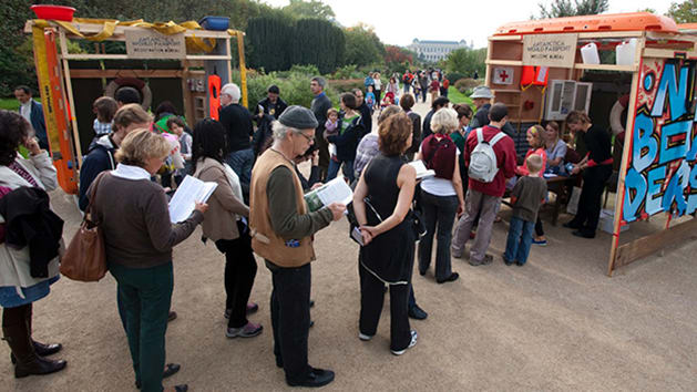 Photo of a group of people queueing outside a booth