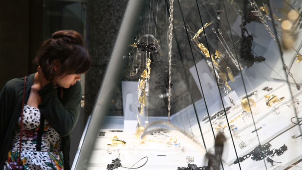 Woman leaning over and looking at an exhibit