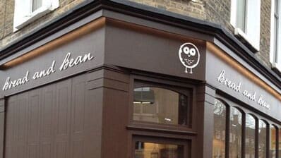 The top of a brown building, 'Broad and Bean' is written on the left hand side of the building