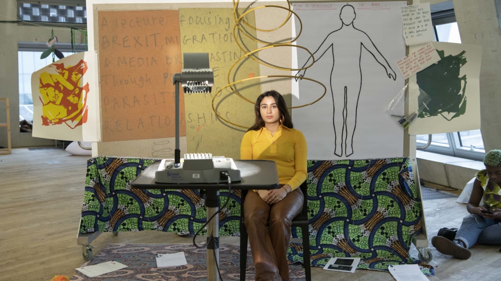 Woman sitting at design in front of presentation