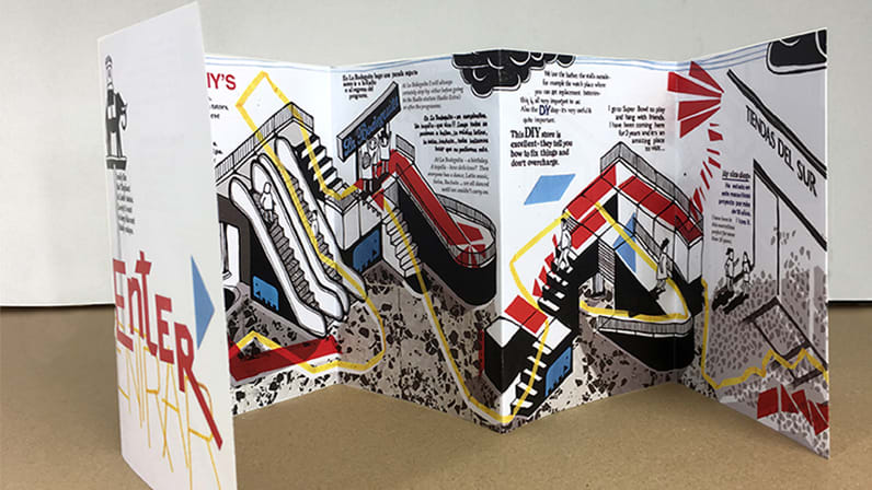 Photograph of an illustrated pamphlet standing up