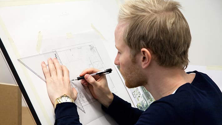 A blonde man drawing