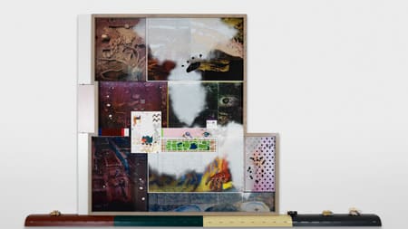 A collage of photographs and different imagery presented against a white wall