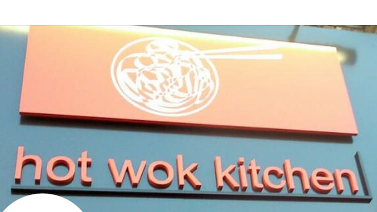 An orange sign that says 'Hot Wok Kitchen'