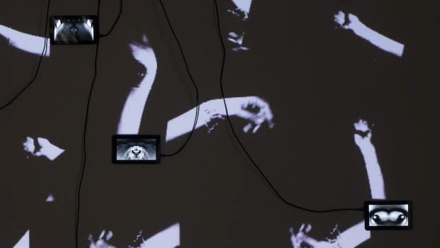 Tablets or screens on a wallpapered wall 