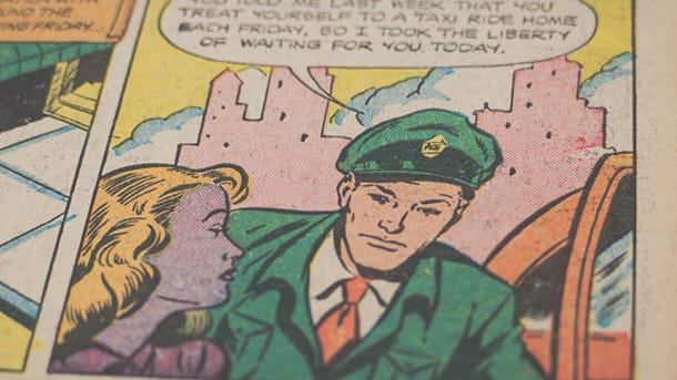 Close-up of a comic book, showing a man and woman interacting