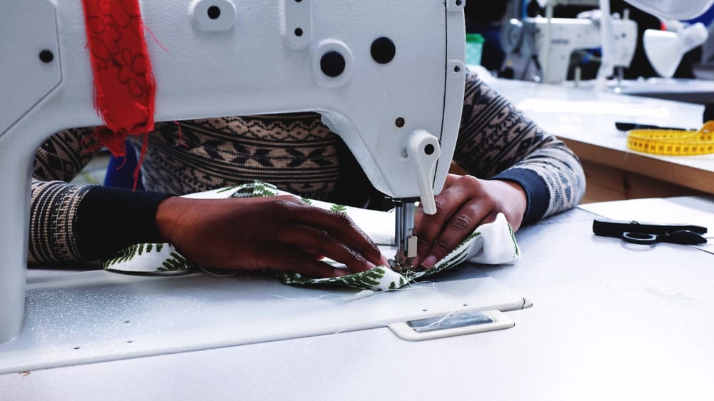 Making for Change participant using a sewing machine