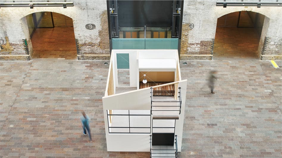 Replica structure of room set within larges brick space