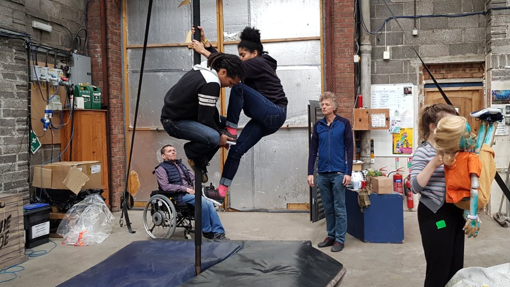 People in a studio practicing a performance