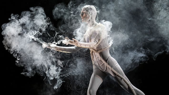 Photo of a man in a costume surrounded by smoke
