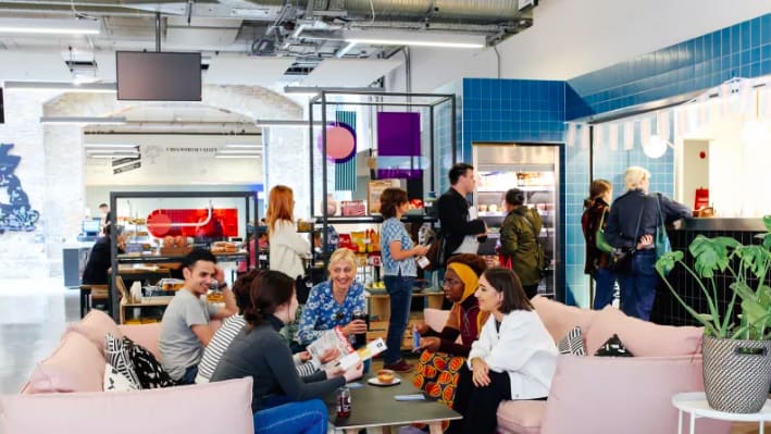 Photogprah of a busy canteen with people sat eating and talking