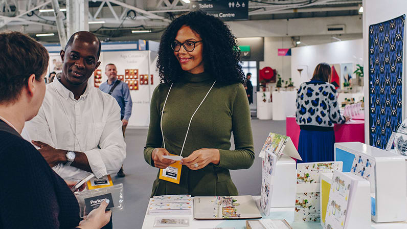Photo of designer Michelle Njeri Small talking to buyers