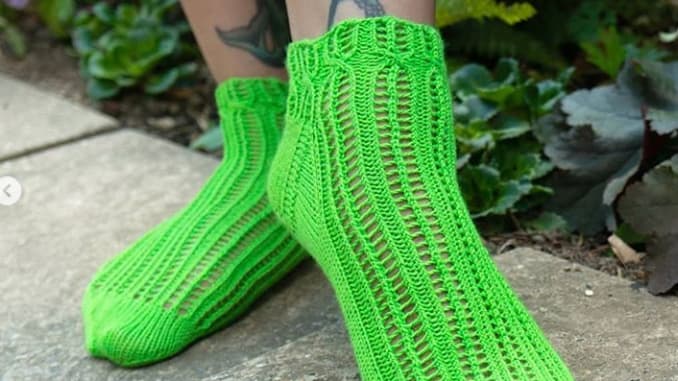 green knitted socks on tatooed leg