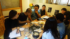 Photo of a group of people sitting around a table in a restaurant