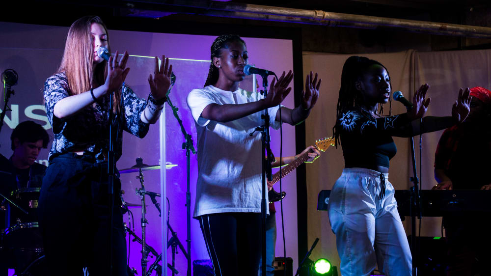 3 students performing at Origins Creatives