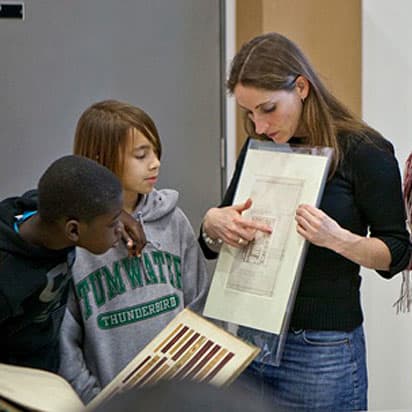 Judy Willcocks, Head of the Museum and Study Collection at Central Saint Martins, showing students a paper archive