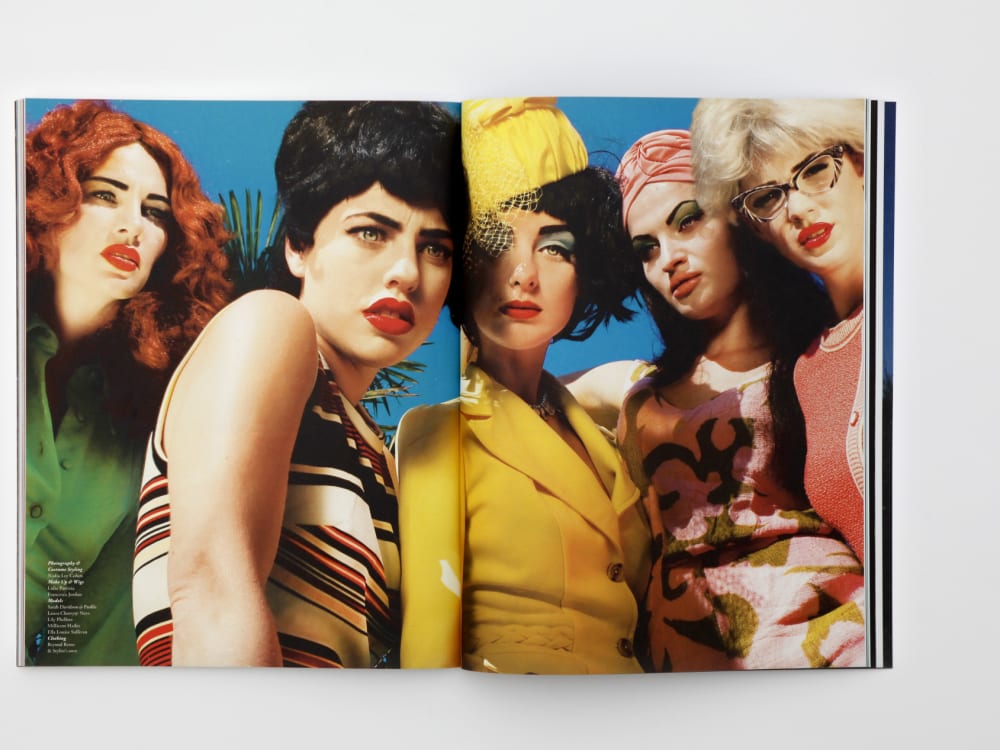 Double spread of Pigeons and Peacocks magazine featuring female models in striking colour outfits.