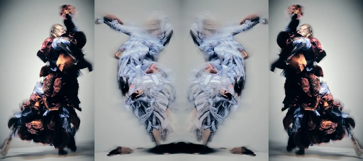 Dancers, blurred, in large costumes.