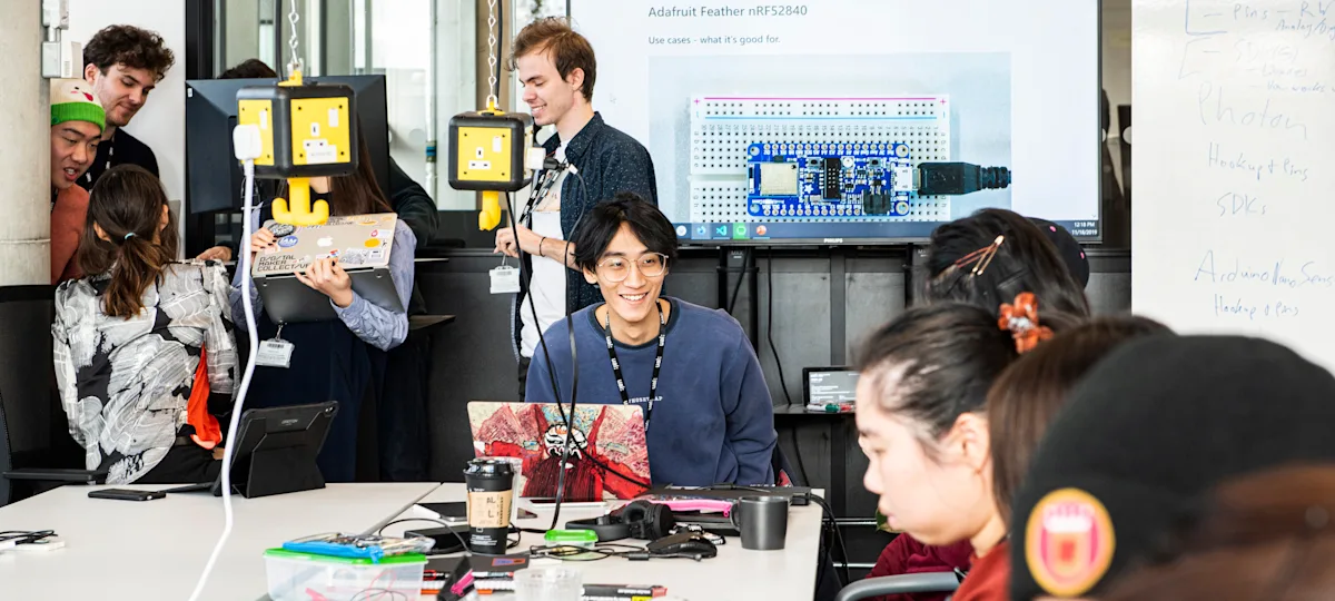 Students working in the studio surrounded by computing equipment