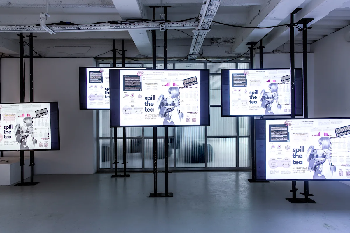 Digital installation showing student work across multiple screens.
