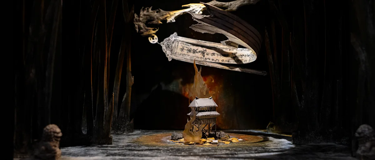 A shadowy, mystical scene depicts a small house on a rock amid dark, towering trees. Above, a ghostly, ornate figure floats, enhancing the eerie atmosphere.