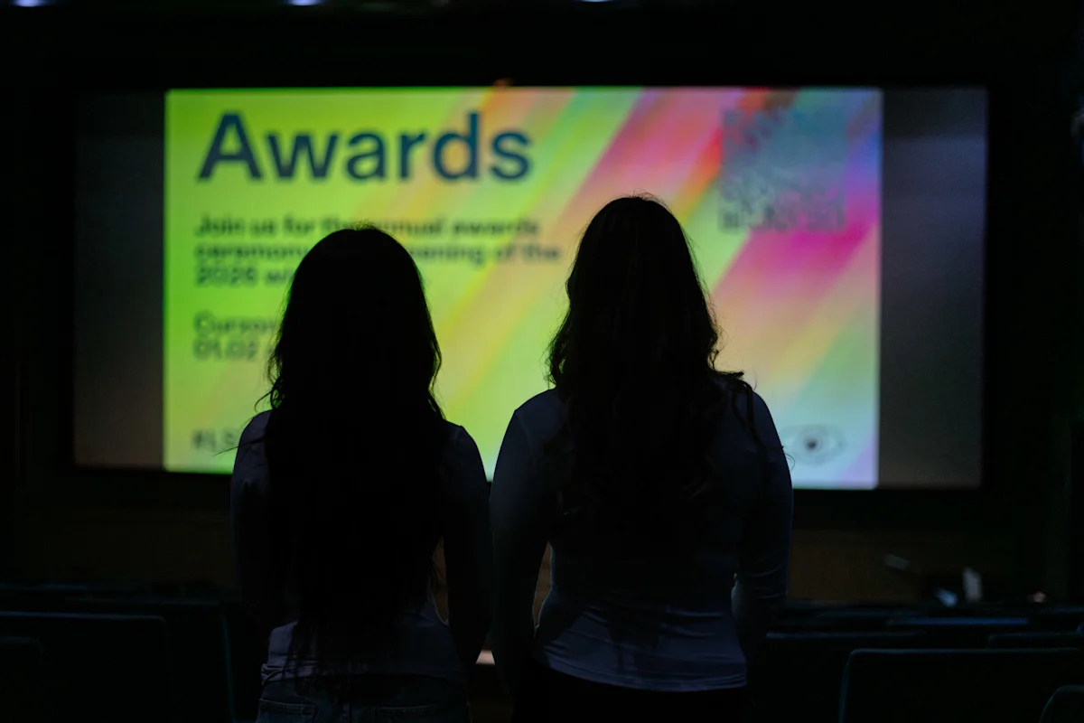 Two students facing the screen at a cinema during London Short Film Festival