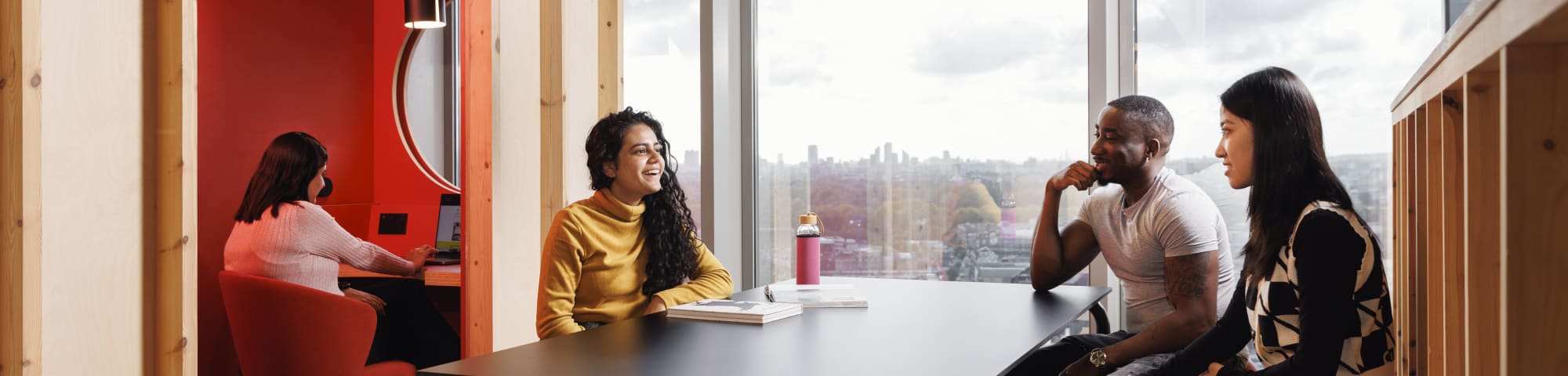 A roof top study area with students sitting at a table