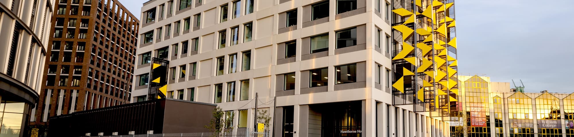 An external view of Hawthorne House, a large tall building. People walking outside the building. 