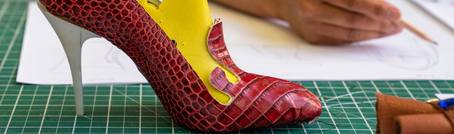 Student sketching heeled shoe