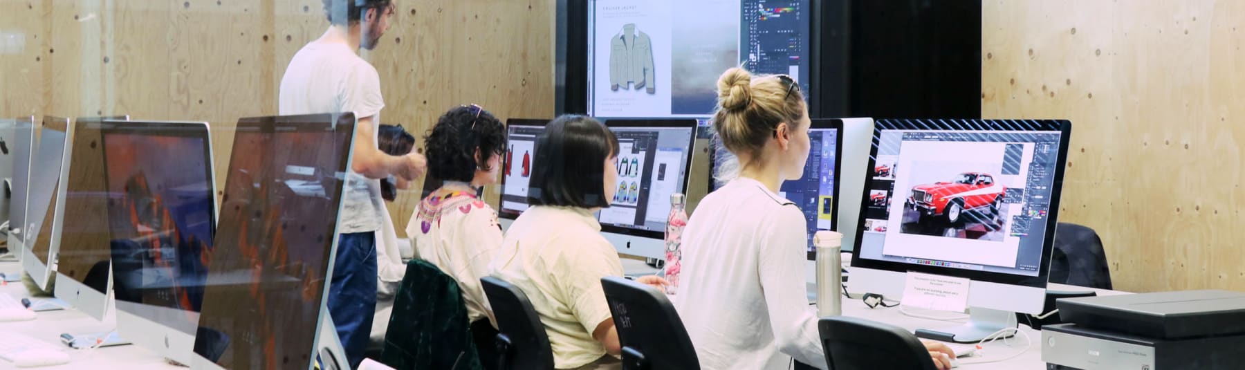 Students working at Mac in a classroom