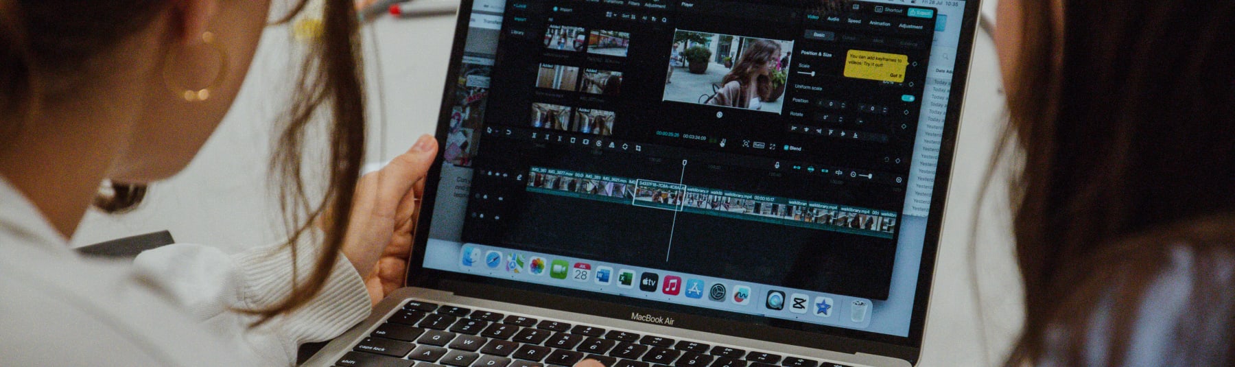 Students video editing on laptop