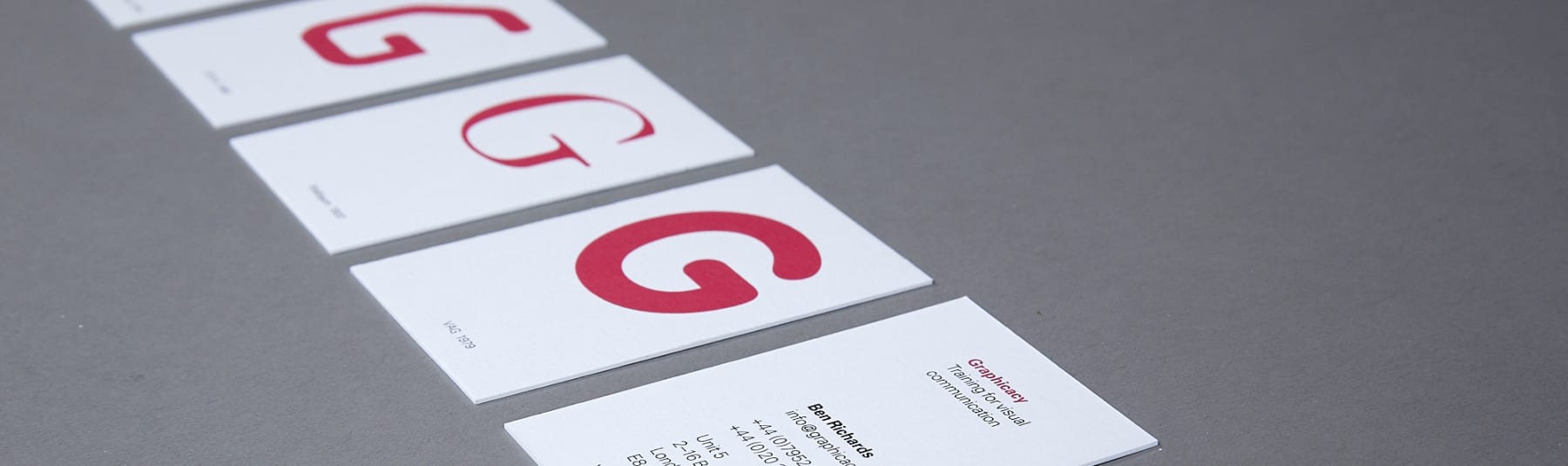 Business cards on table with prominant red G