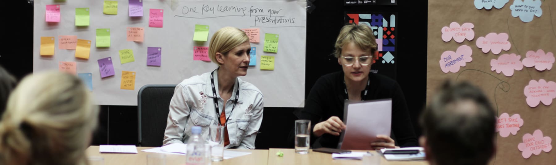 Tutors running a workshop from a table