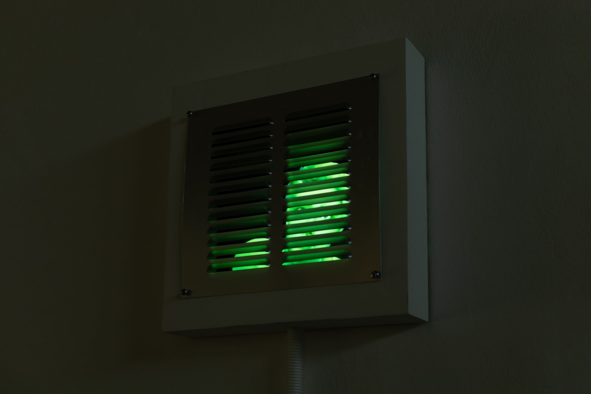 A green superman in the vents begging for help.