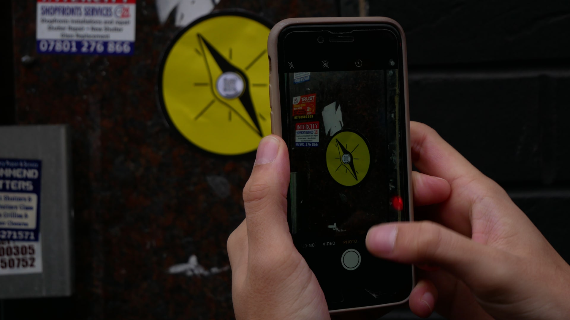 A phone taking a picture of a yellow sticker
