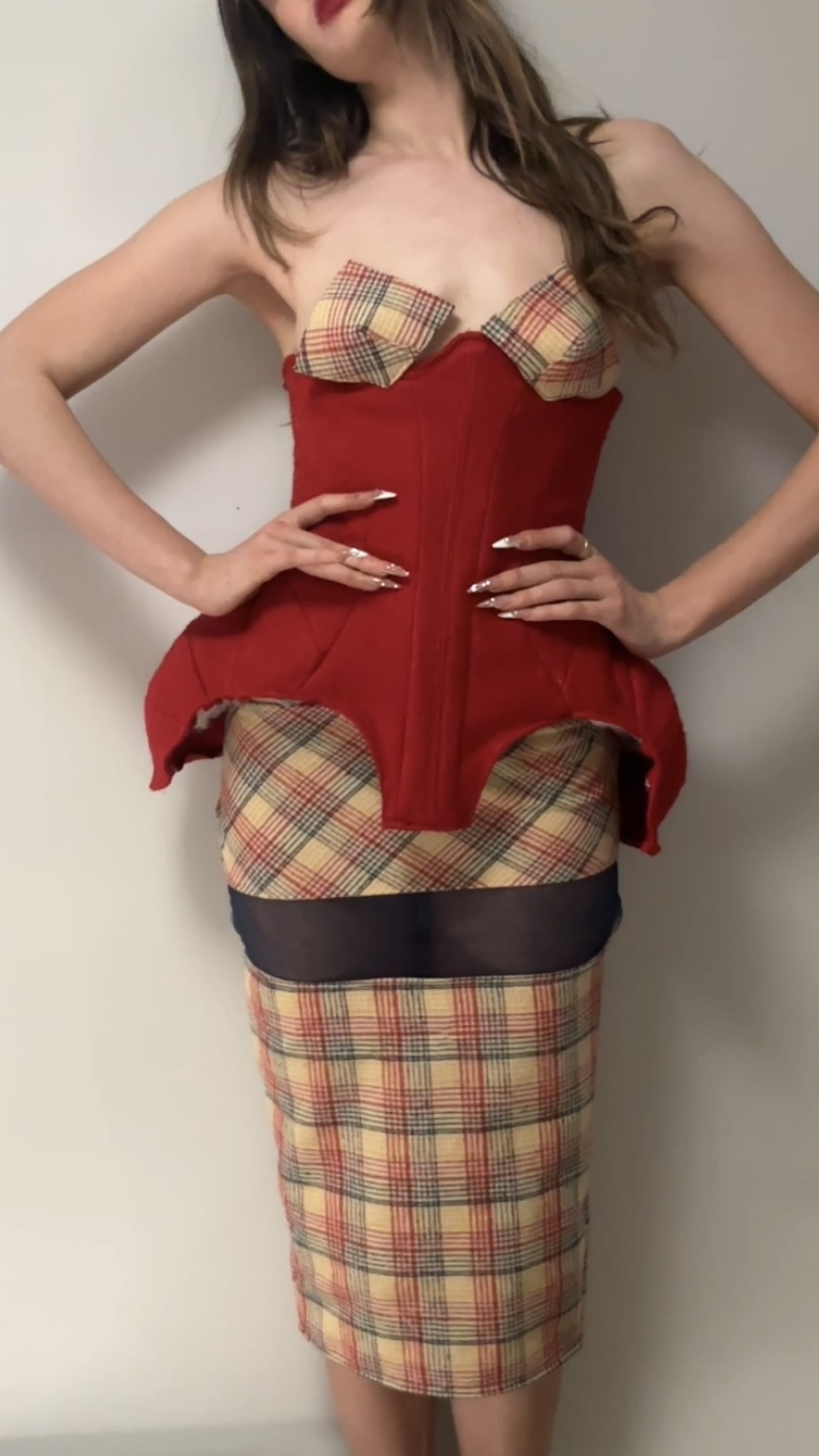 red corset paired with a colourful tartan skirt