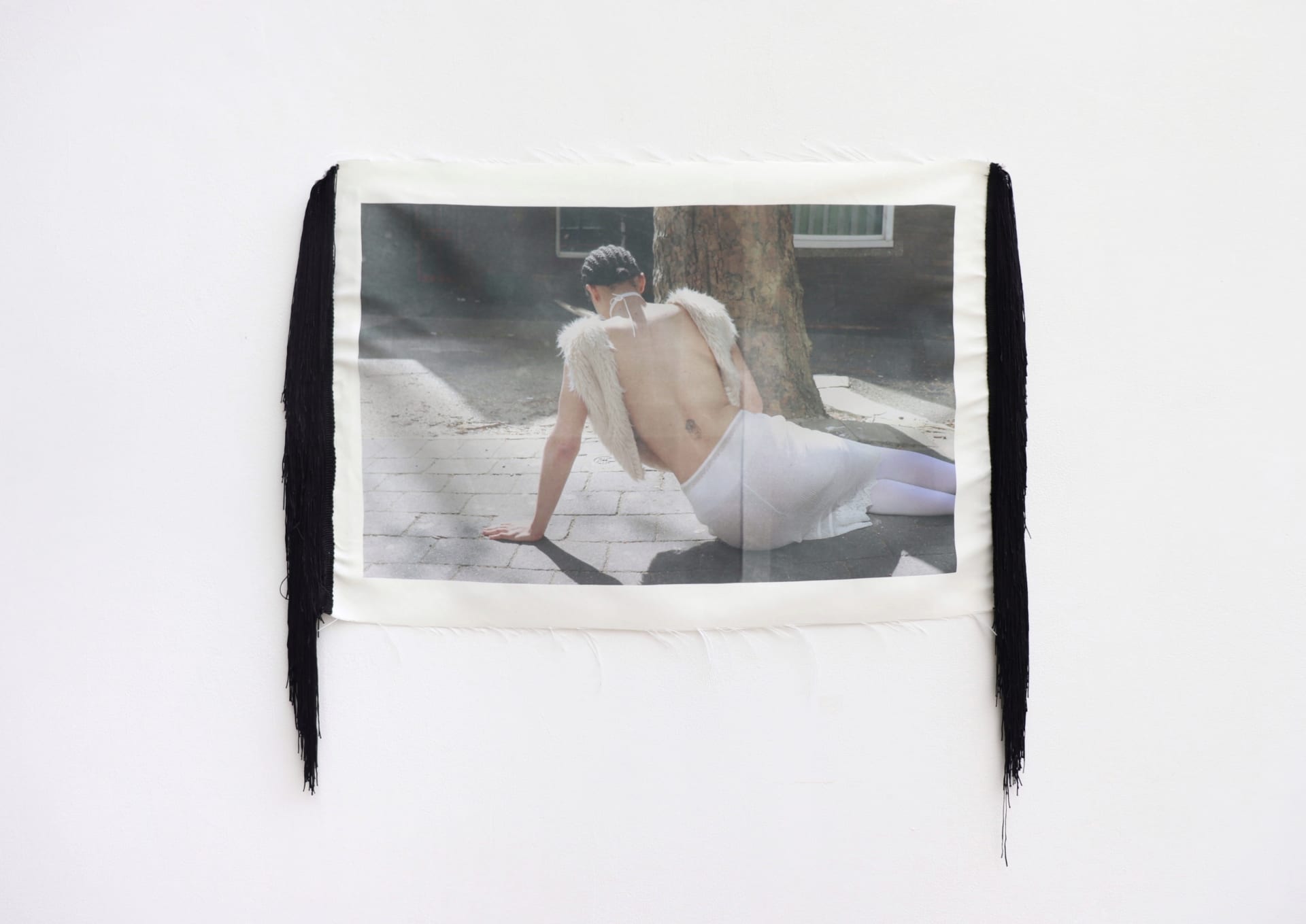 Heat printed image on polyester with sewn tassels on the side