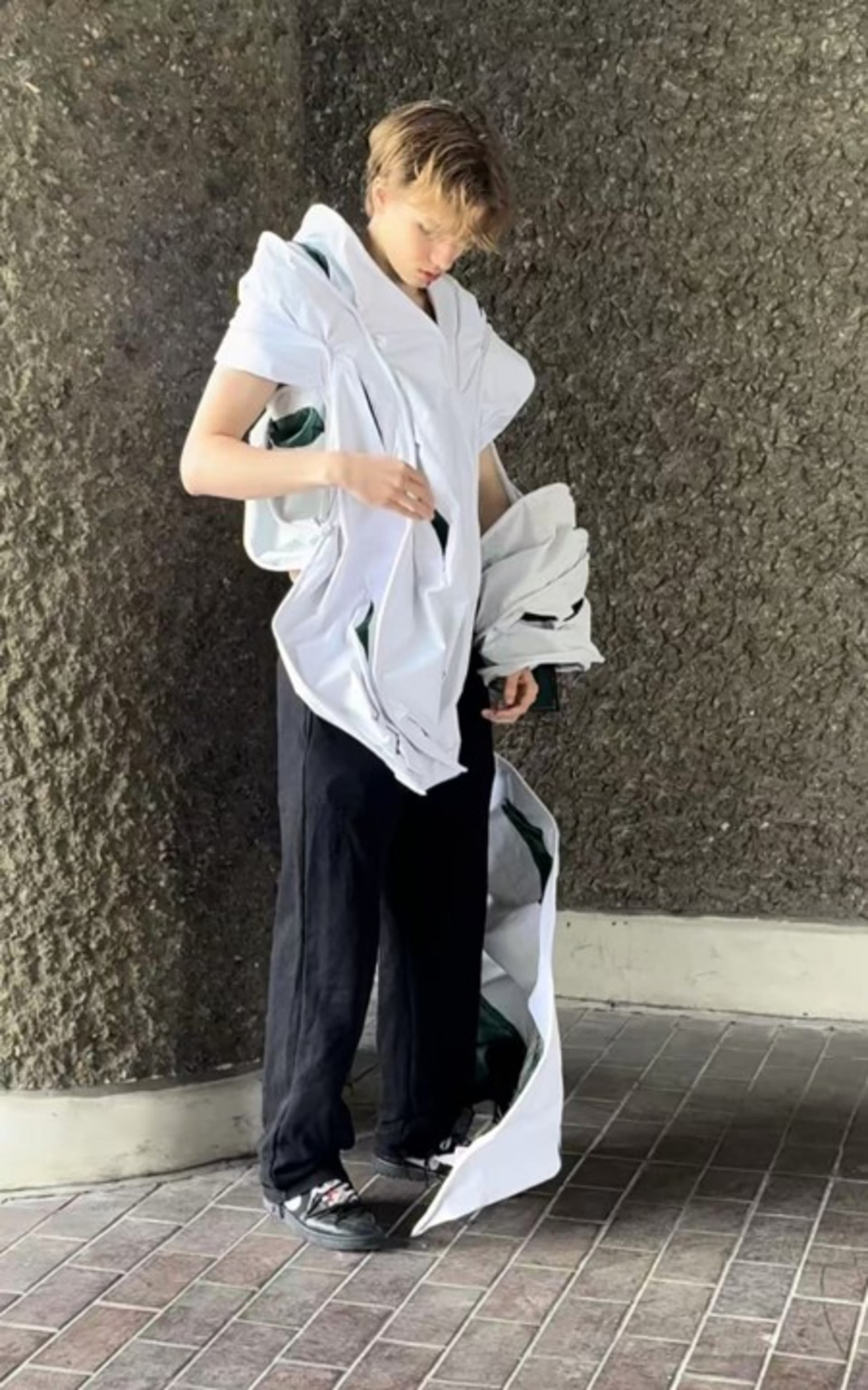Man standing front 45 degrees in pocketed wired pleat garment