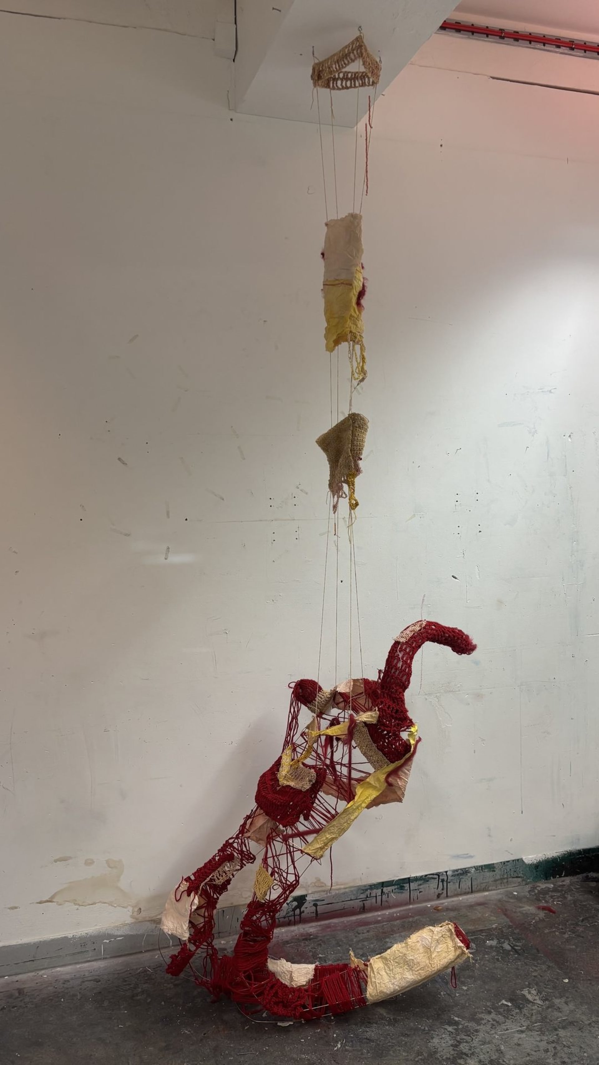 metal sculpture of body with fabric draped .