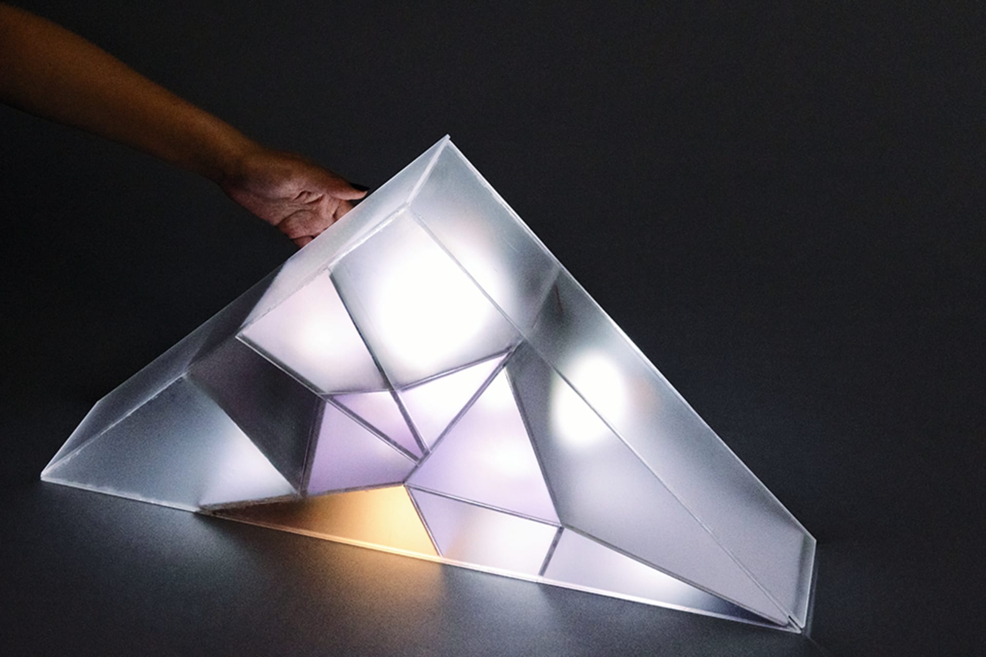 a hand is touching the switch to turn on the light-showing the interaction between user and the lamp