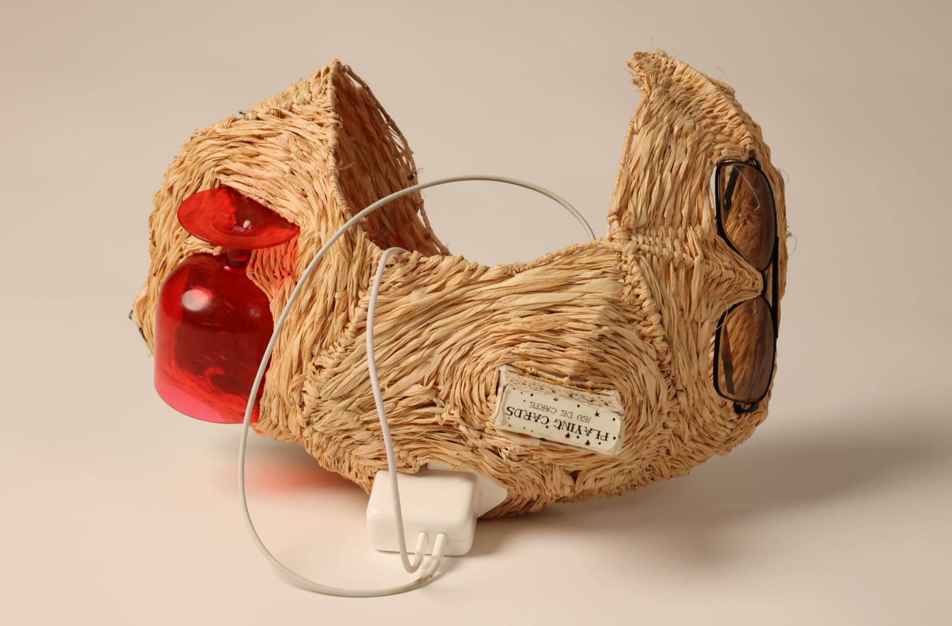 Raffia bag with displaced items inside