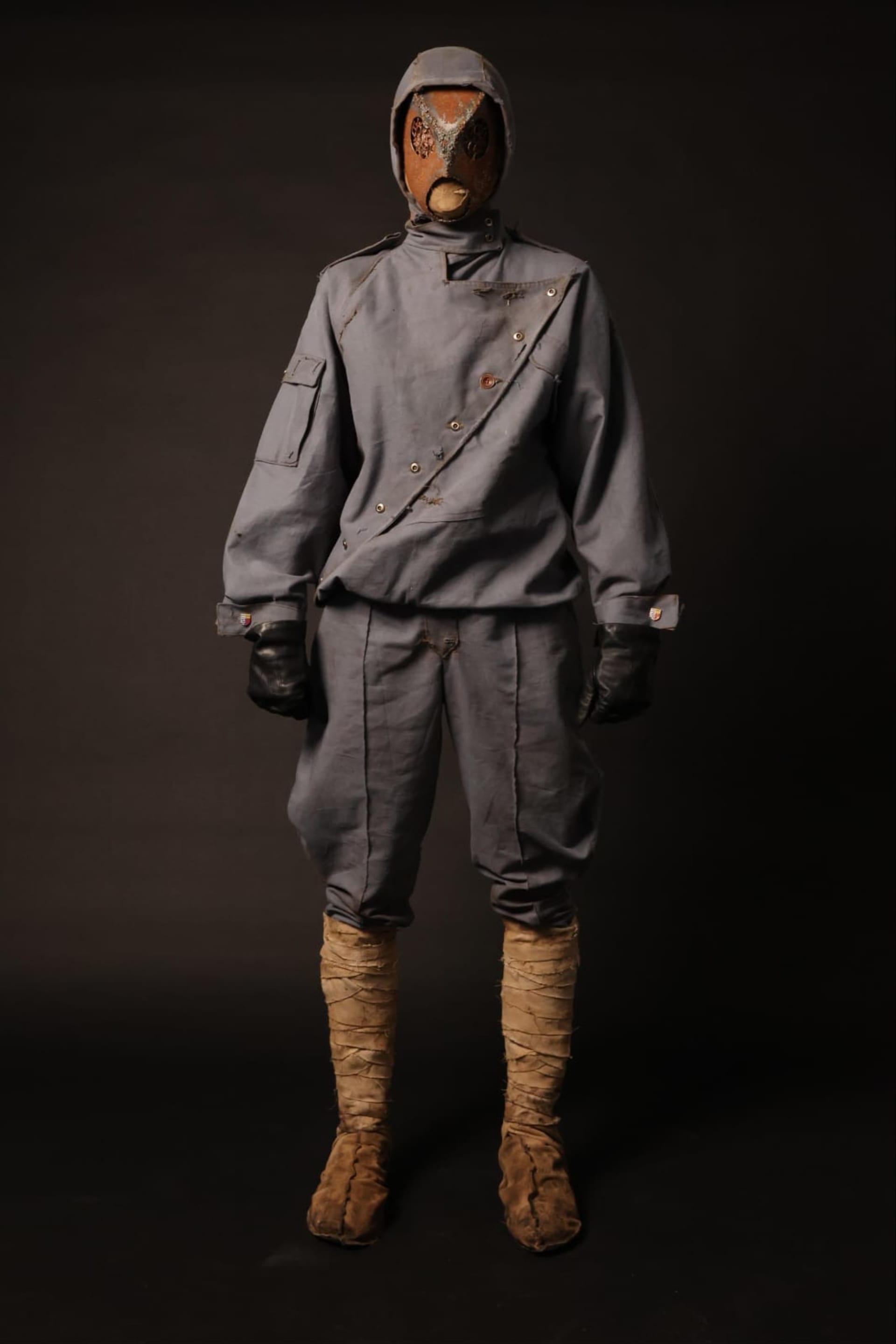Full body shot of the whole costume, a metal mask and blue-grey soldier's uniform