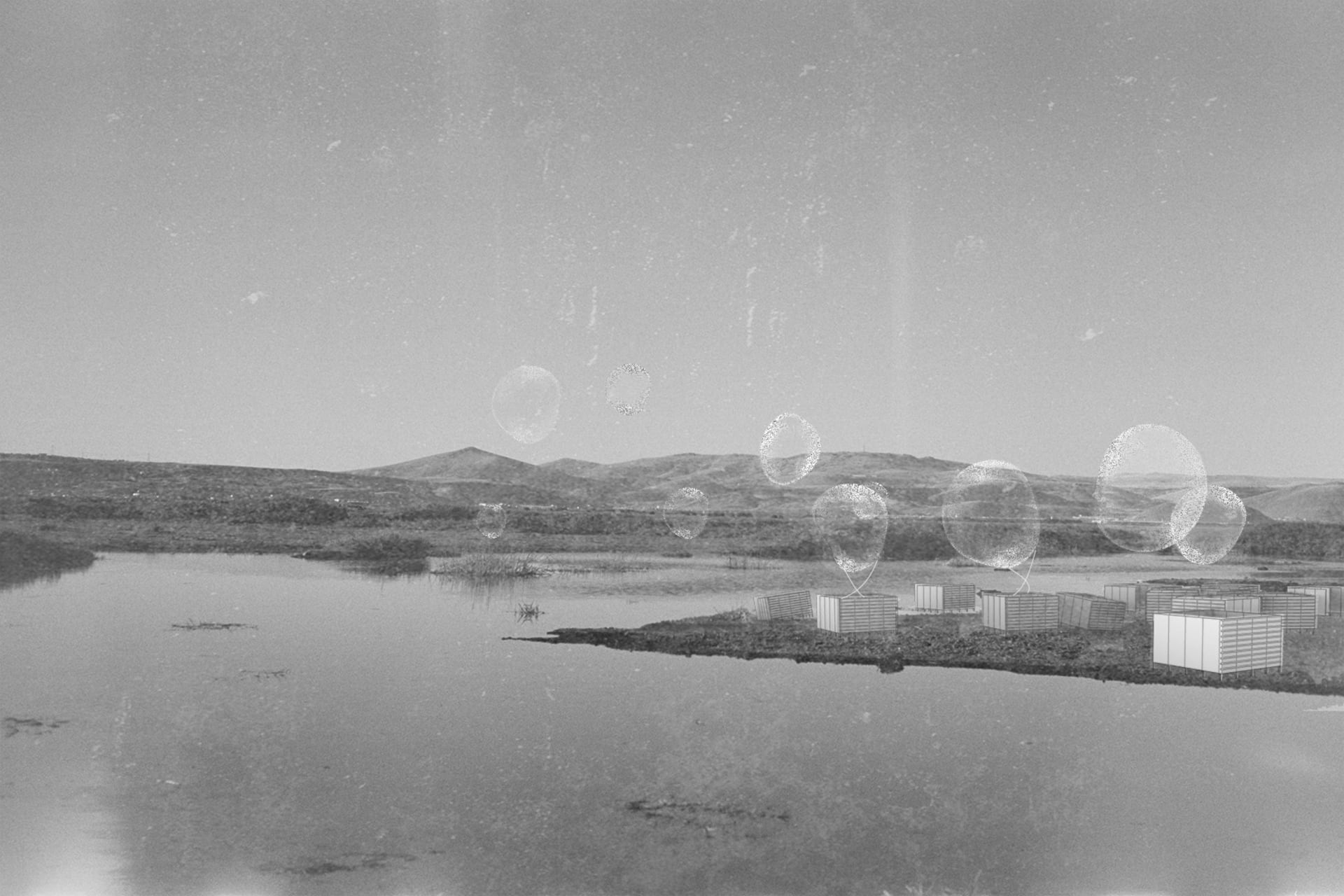 Transparent bubbles rise from cubicle-like structures on a riverside landscape under a wide sky.