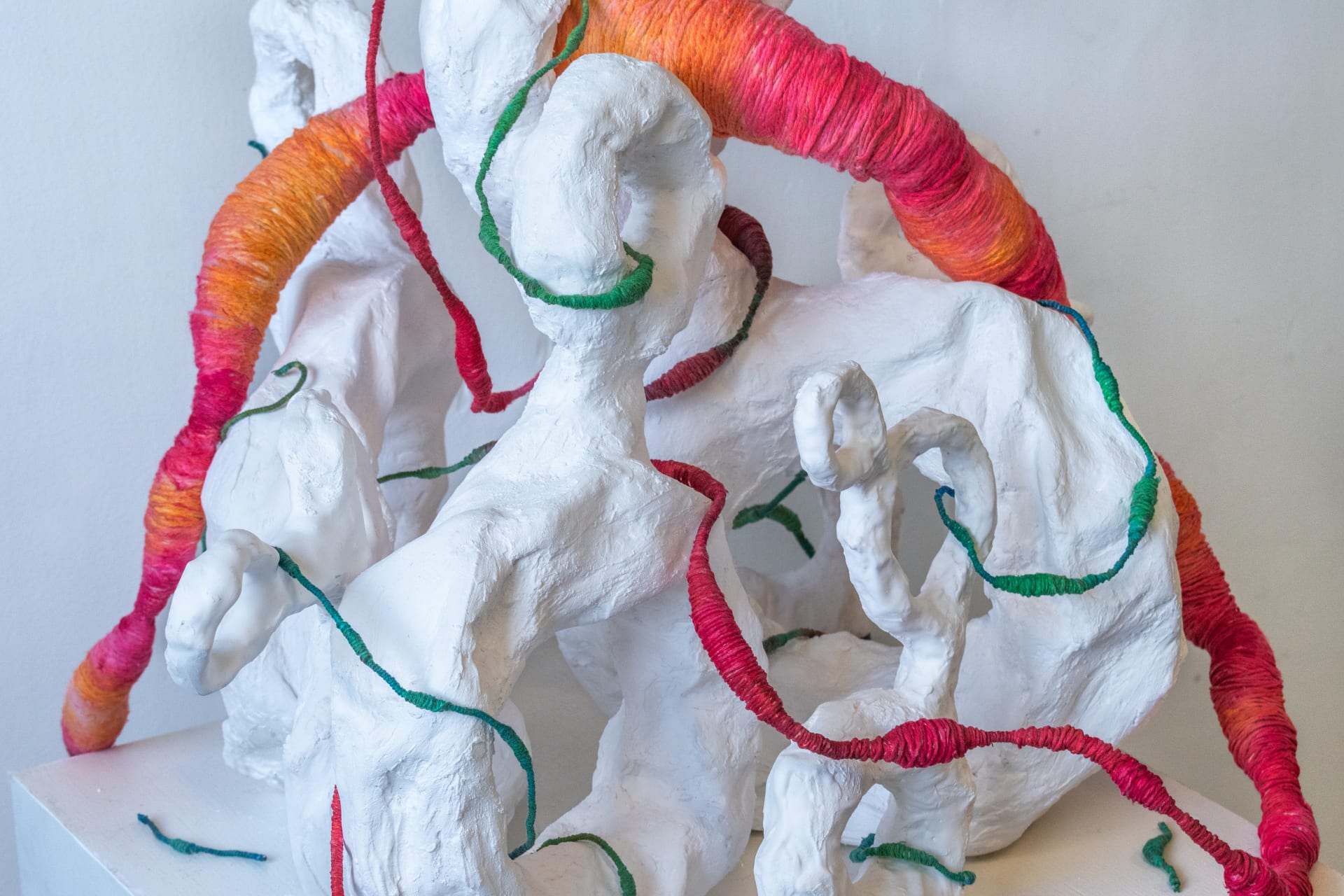 Biomorphic shapes with a parasitic tapeworm moving through the sculpture
