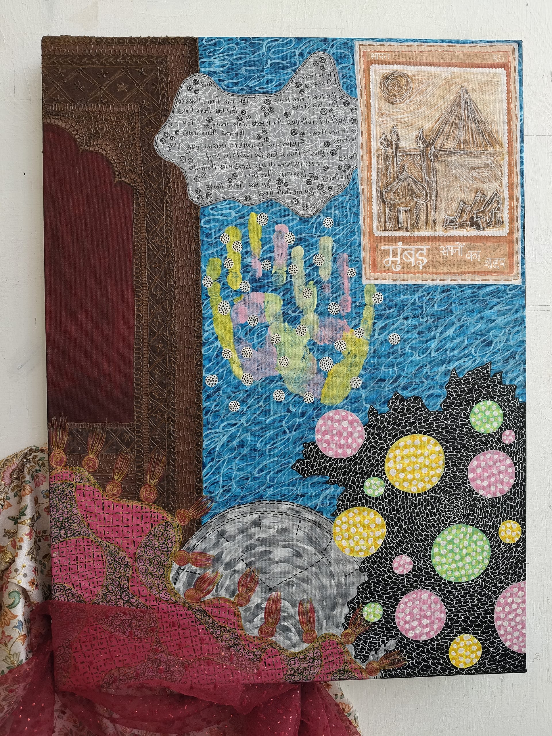 This canvas features swirling blue water, colorful handprint, dotted circles, traditional architectural motif, Gujarati script, post stamp and textile