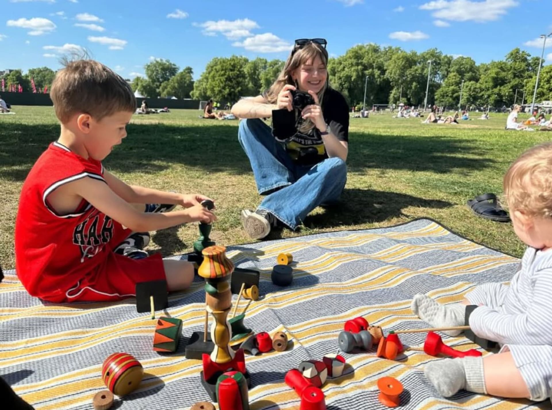 me and two children playing with the final prototype of the toy for user testing and feedback
