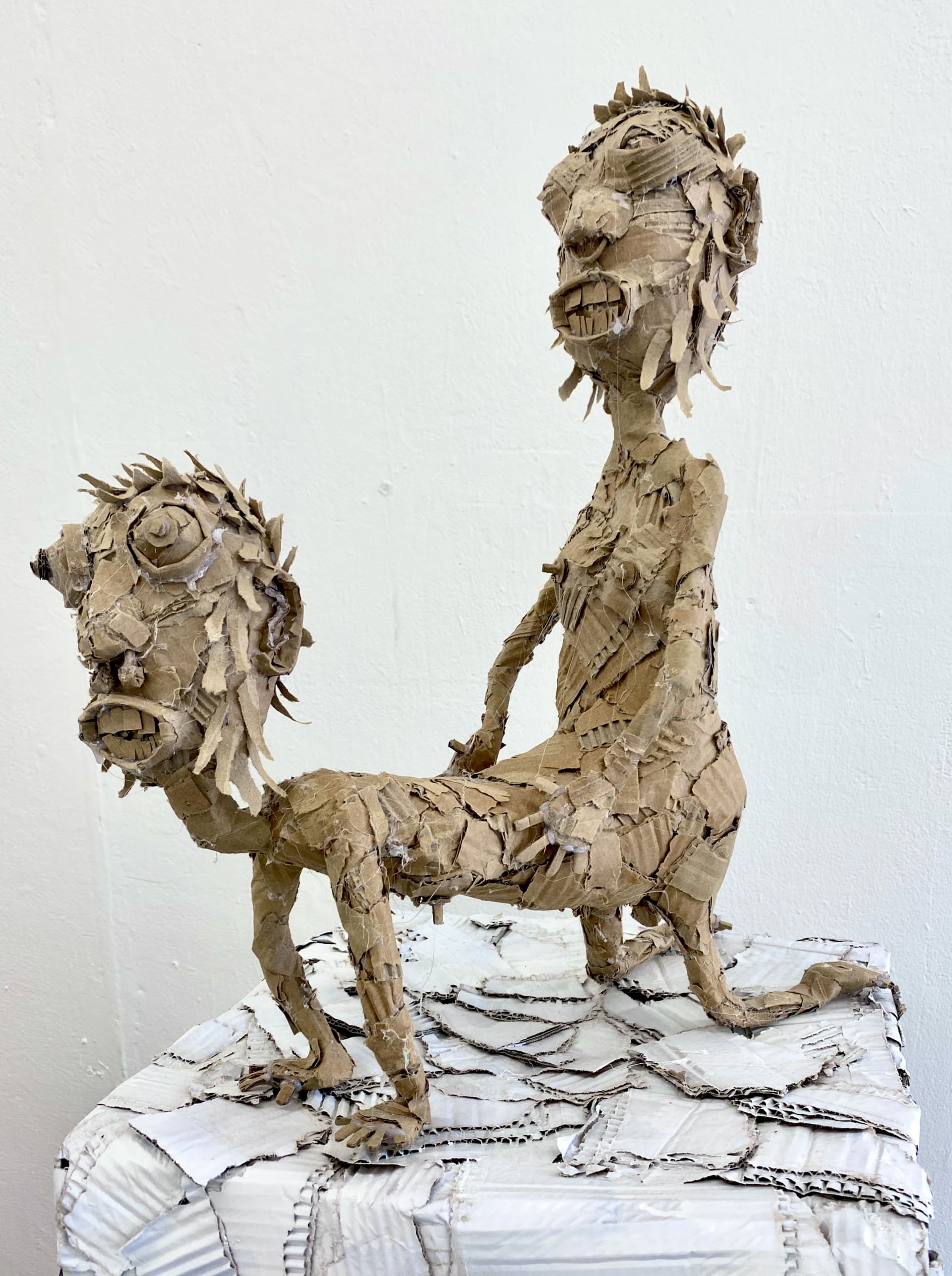 A creature like sculpture that appears to be fornicating but is fused to itself 